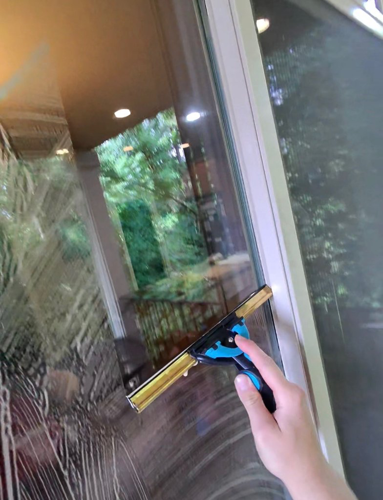 Hand-squeegeeing an interior window pane